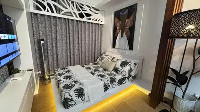 a living room with a couch in a room at 1BR Pioneer Woodland Condominium connected to BONI Metro Rail Station,Boni Mandaluyong Metro Manila in Manila