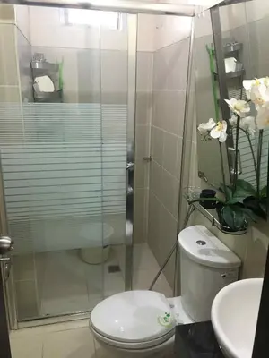 a bathroom with a shower and a toilet and a sink at 1BR Pioneer Woodland Condominium connected to BONI Metro Rail Station,Boni Mandaluyong Metro Manila in Manila