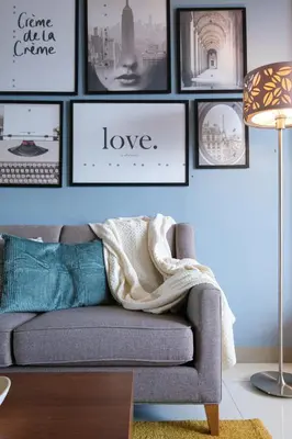 a living room with a couch and pictures on the wall at Solstice at BGC- Modern & Stylish 1BR in Uptown BGC in Manila