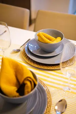 a table with a bowl of food on a table with glasses at Solstice at BGC- Modern & Stylish 1BR in Uptown BGC in Manila