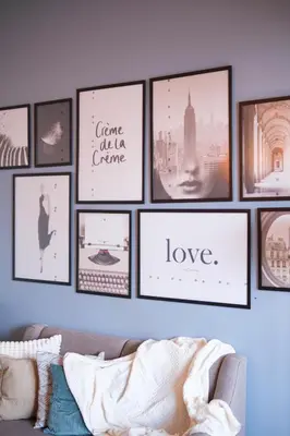 a bunch of pictures on a wall with a couch at Solstice at BGC- Modern & Stylish 1BR in Uptown BGC in Manila