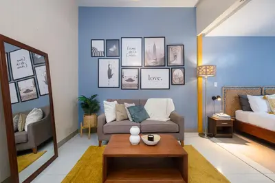 a living room with a couch and a table at Solstice at BGC- Modern & Stylish 1BR in Uptown BGC in Manila