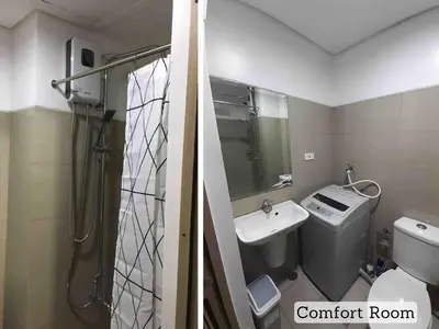 a bathroom with a shower and a toilet and a sink at Erick 1 bedroom Shore Residence 1 in Manila