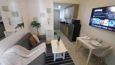 a living room with a couch and a table at Erick 1 bedroom Shore Residence 1 in Manila