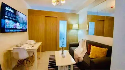 a living room with a couch and a table at Erick 1 bedroom Shore Residence 1 in Manila