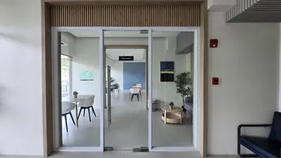 a glass door leading into a room with a table and chairs at Urban Oasis Cozy Studio at Berkeley Suites South Forbes Nuvali in Silang