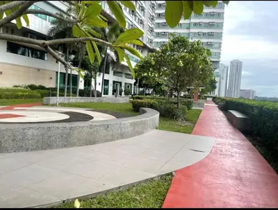 a red path in a park next to a building at Minimalist Cozy condo in Makati,Netflix,Sauna,Pool in Manila