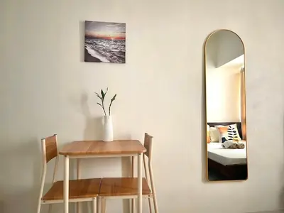 a room with a table and a mirror at Minimalist Cozy condo in Makati,Netflix,Sauna,Pool in Manila