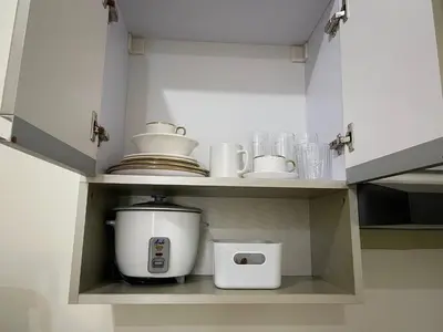 a kitchen cabinet with a coffee maker and a toaster at Minimalist Cozy condo in Makati,Netflix,Sauna,Pool in Manila