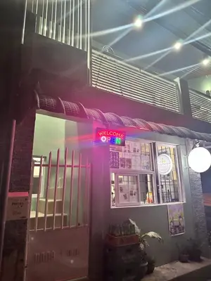 a restaurant with a neon sign on the side of a building at SJ Vistacation