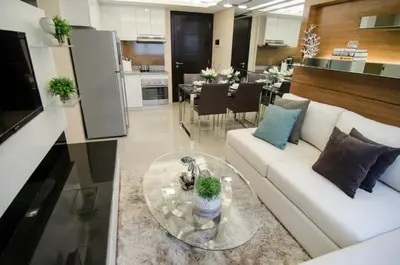 a living room with a white couch and a table at Cozy Condo in Manila