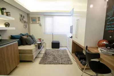 a small room with a couch and a table in a kitchen at Cozy Condo in Manila