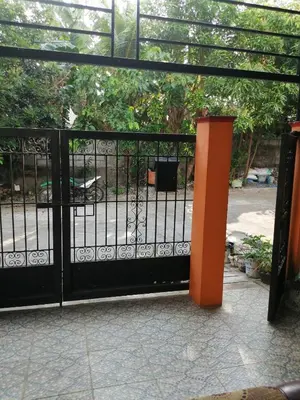 a black gate with an orange pillar in front of it at 1 Bedroom Townhouse with Airconditon ,Water heater and free wifi,fully furnished in San Roque