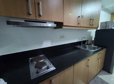 a kitchen with a sink and a black counter top at Buong tuluyan sa Pasay in Manila