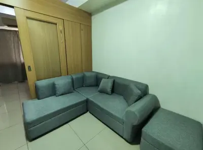 a living room with a blue couch in a room at Buong tuluyan sa Pasay in Manila