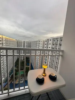 a balcony with a table and two cups on it at Shore Residence Casa Margarita in Manila
