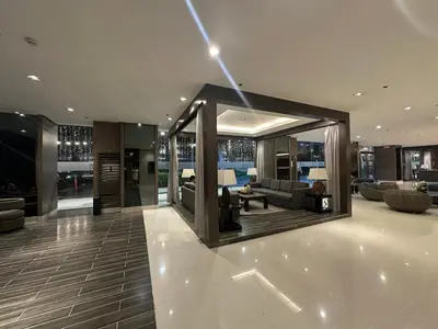 a large living room with a couch and a table at Shore Residence Casa Margarita in Manila