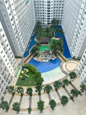 an overhead view of a water park with tall buildings at Shore Residence Casa Margarita in Manila