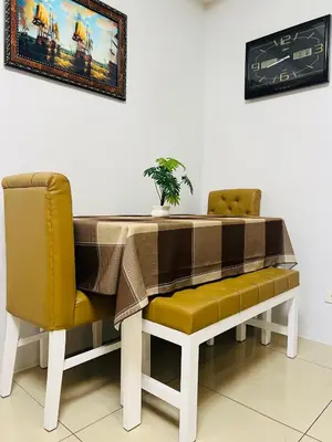 a table and a chair with a plant on it at Shell Residences MOA Paul's Place in Manila
