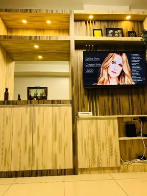 a tv on the wall of a hair salon at Shell Residences MOA Paul's Place in Manila