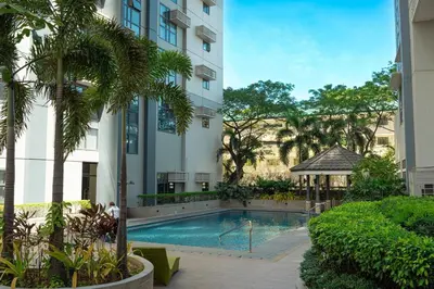a swimming pool in front of a building with a gazebo at Stingga McKinley Aesthetic Studio in Venice in Manila
