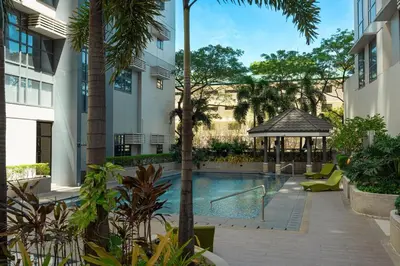 a swimming pool with a gazebo next to a building at Stingga McKinley Aesthetic Studio in Venice in Manila