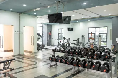a gym with a lot of treadmills and weights at Stingga McKinley Aesthetic Studio in Venice in Manila