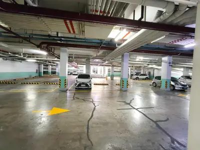 an empty parking garage with a car parked in it at Asthrea Condotels in front of NAIA Terminal 3 Airport in Manila