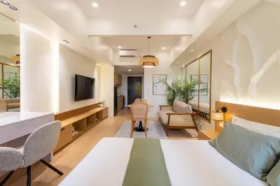 a hotel room with a bed and a tv at Luxury 1 BR City View in Park Mckinley West Fast Wi-Fi Washer Dryer in Manila