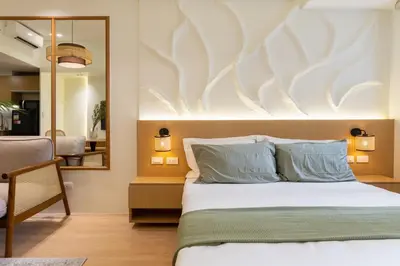 a bedroom with a bed and a mirror at Luxury 1 BR City View in Park Mckinley West Fast Wi-Fi Washer Dryer in Manila