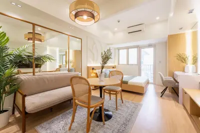 a living room with a couch and a table at Luxury 1 BR City View in Park Mckinley West Fast Wi-Fi Washer Dryer in Manila