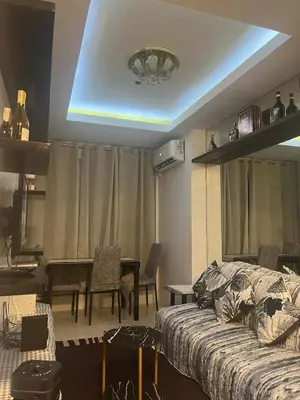 a living room with a couch and a table at JFS Home at Birch Tower 1BR in Manila