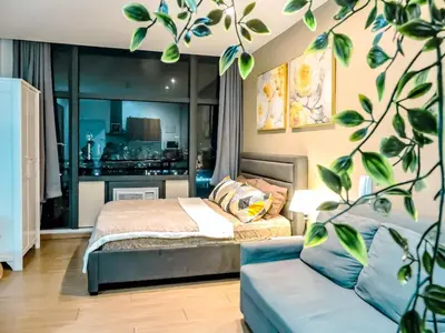 a bedroom with a bed and a couch at Gramercy Makati Studio with Free Pool Gym and Sauna in Manila