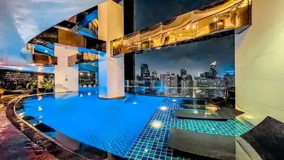 a pool on the roof of a building with a city skyline at Gramercy Makati Studio with Free Pool Gym and Sauna in Manila