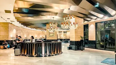 a lobby of a hotel with people sitting at a bar at Gramercy Makati Studio with Free Pool Gym and Sauna in Manila