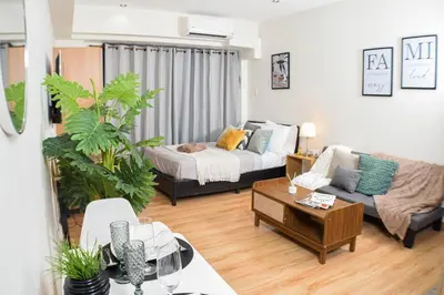 a living room with a couch and a table at Vue Urbain Moderne - Knightsbridge Poblacion Makati Studio in Manila