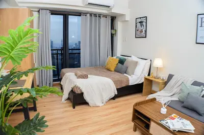 a living room with a bed and a couch at Vue Urbain Moderne - Knightsbridge Poblacion Makati Studio in Manila