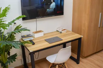 a desk with a laptop and a chair in a room at Vue Urbain Moderne - Knightsbridge Poblacion Makati Studio in Manila