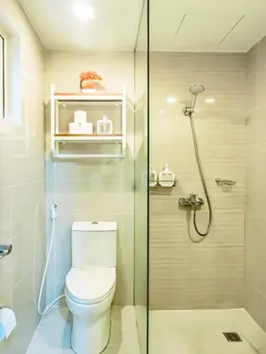 a bathroom with a toilet and a shower at Central Makati Studio with Gym Pool and Massage Room in Manila