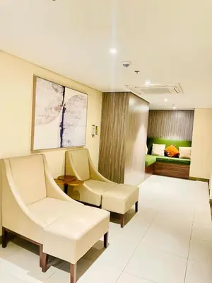 a hospital room with two chairs and a bed at Central Makati Studio with Gym Pool and Massage Room in Manila