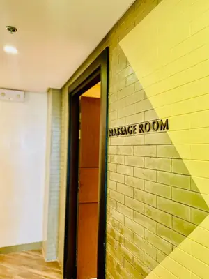 a brick wall with a sign that reads massage room at Central Makati Studio with Gym Pool and Massage Room in Manila
