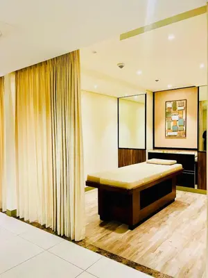 a bedroom with a bed and a mirror at Central Makati Studio with Gym Pool and Massage Room in Manila