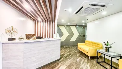 a lobby with a reception desk and a yellow chair at Central Makati Studio with Gym Pool and Massage Room in Manila