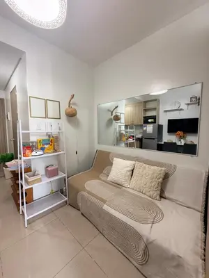 a bedroom with a bed and a living room at Affordable Stay at Shore Residence near MOA by VCA Staycation in Manila