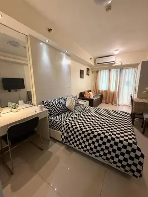 a bedroom with a black and white checkered bed at Sea Residences Staycation SMDC Property in Manila