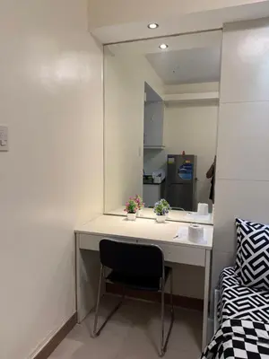 a room with a desk with a chair and a mirror at Sea Residences Staycation SMDC Property in Manila