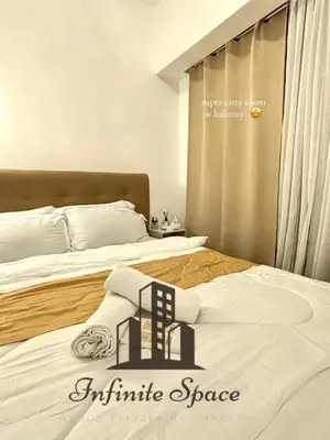 a bedroom with two beds with white sheets at Staycation in Detifoss in Manila