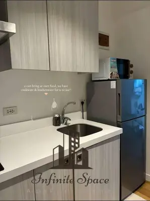 a kitchen with a sink and a blue refrigerator at Staycation in Detifoss in Manila