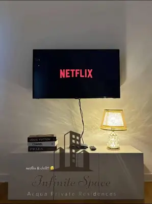 a nittilix sign above a table with a lamp at Staycation in Detifoss in Manila