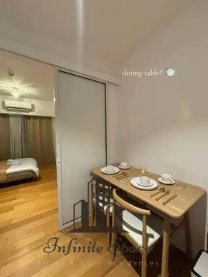 a dining table and chairs in a room with a bedroom at Staycation in Detifoss in Manila